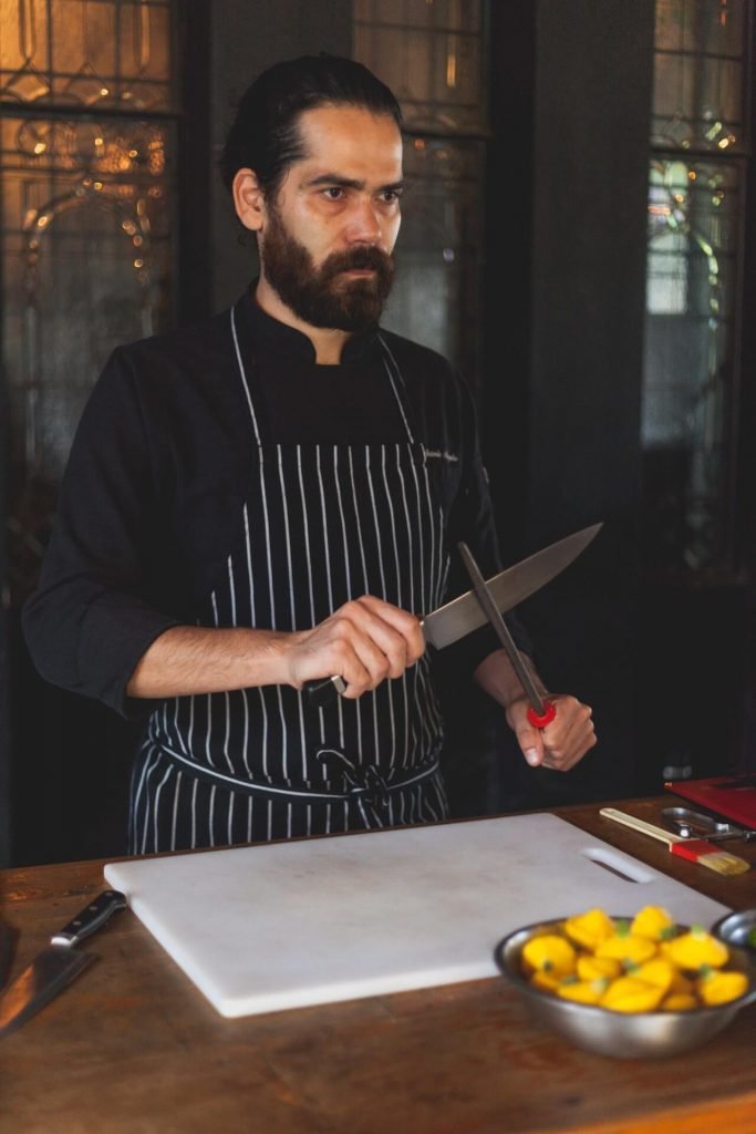 A master chef sharpening his knife
